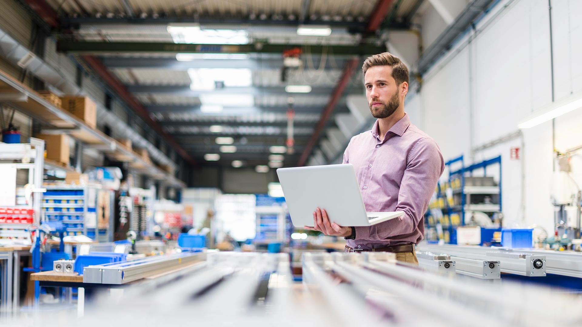 man using laptop in a production room