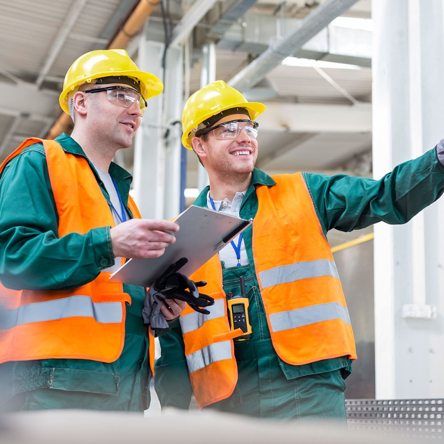 Two construction worker in safety clothing discussing at site
