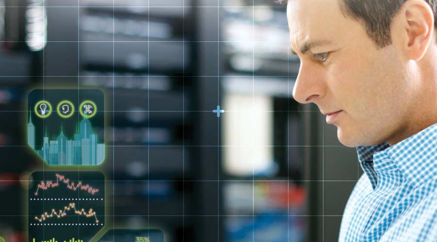 Man is able to monitor the energy management software from a tablet in the server room, sustainability reporting, data center management, internet of things.